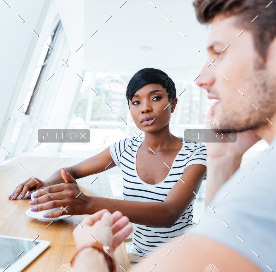 demo attachment 307 businesswoman and smiling businessman discussing work in restaurant@2x